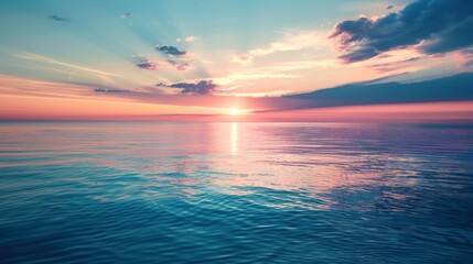 Obraz premium A stunning sunset over a calm ocean, capturing vibrant colors reflected on the water and sky, symbolizes peace, beauty, and the infinite calmness of nature at dusk.