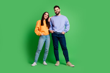 Photo of happy charming couple husband and wife wear stylish outfit isolated on green color...