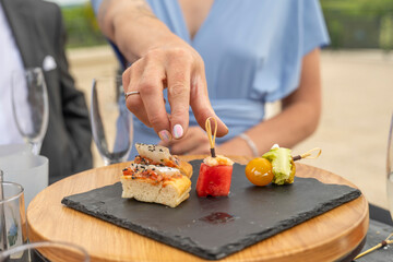 main d'une femme prête à saisir un petit four sur un plateau