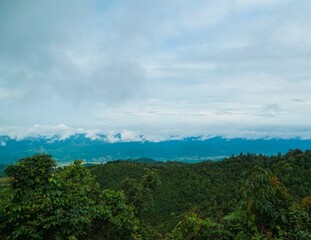 The sky is cloudy and the mountains are in the background