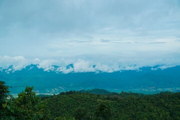 The sky is cloudy and the mountains are in the background
