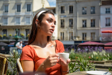 Caucasian woman having coffee on a bar terrace