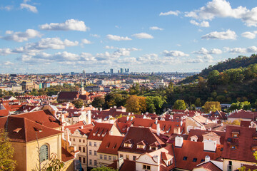 Obraz premium View of Historic Rooftops in Prague. Panoramic view of red rooftops in historic Prague under a clear blue sky, showcasing architectural charm and urban beauty.