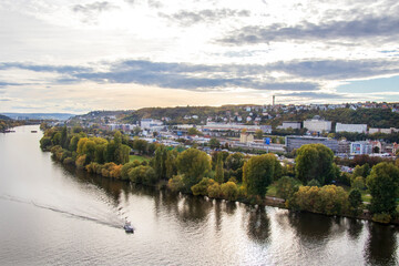 Obraz premium panoramic view of autumn Prague in October, view of the river with a boat and the city in October