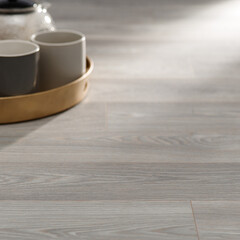 Elegant Light Oak Wood Flooring with Tea Set on a Golden Tray in a Cozy Modern Interior Setting