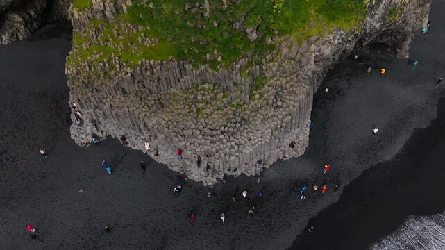 The footage of Reynisfjara Beach and H&aacute;lsanefshellir Cave, showcasing unique basalt columns. This popular Icelandic attraction highlights the raw beauty and striking geological formations of the area.