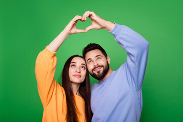 Photo of pretty lovely cute couple wear stylish clothes arms above head heart shape empty space...