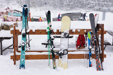 Skis, ski poles and snowboards are fully equipped on snow-covered mountain top during the ski season