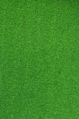 Artificial grass, covering. Artificial green grass mat, top view. Texture. Background. Artificial turf, surface made of synthetic fibers. Flat green grass texture background. Short grass
