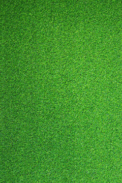Artificial grass, covering. Artificial green grass mat, top view. Texture. Background. Artificial turf, surface made of synthetic fibers. Flat green grass texture background. Short grass