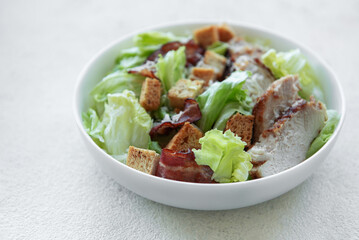 A bowl  of  Caesar salad