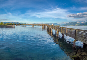 Line fishing on the historical wooden bridge near Rapperswil, Upper Zürich Lake, St. Gallen, Switzerland