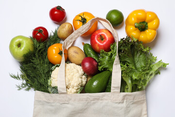 Delivery of vegetarian products. Bag with different vegetables and fruits on white background, top view