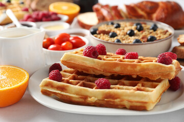 Different meals served for breakfast on white table, closeup. Buffet menu