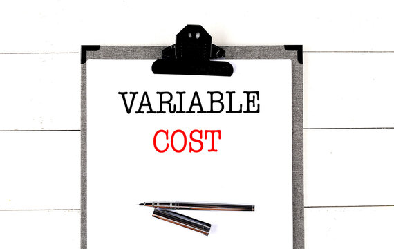 VARIABLE COST text on clipboard on white background