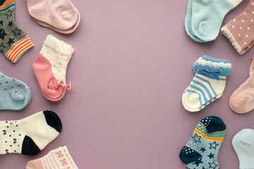 Children's socks on a lilac background. There is space for text. Socks for girls and boys. Clothes for children.