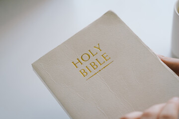 A Christian reads the Bible and drinks coffee. Reading the Holy Bible in temple. Concept for faith, spirituality and religion. Peace, hope, dreams concept