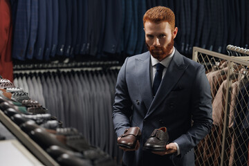 Portrait businessman in suit in footwear shop. Man buy fashion shoes in store