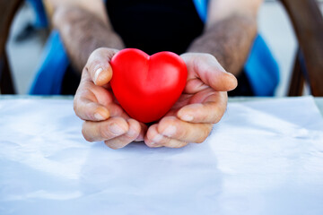 Man's hands and heart in his hands