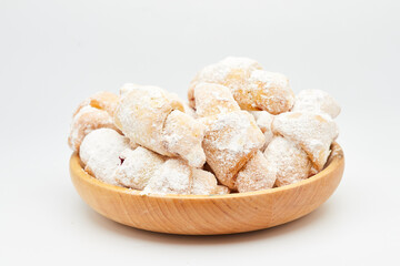 Powdered sugar-coated pastries filled with jam, perfect for sweet cravings and dessert lovers