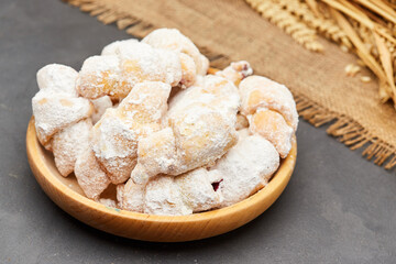 Powdered sugar-coated pastries filled with jam, perfect for sweet cravings and dessert lovers