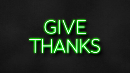 give thanks green neon lettering on plain dark black background