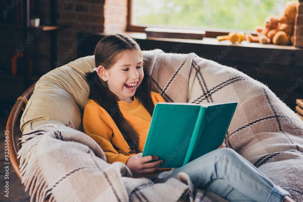 Wall mural photo of positive good mood little girl dressed yellow pullover enjoying fairytale smiling indoors h