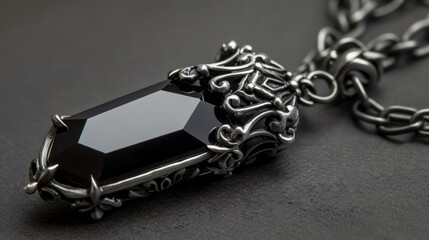 Intricate gothic pendant with a large black gemstone and ornate silver chain