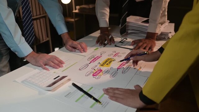 Business team collaborating on strategy with colorful diagrams