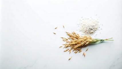 Obraz premium Uncooked White Rice and Golden Oat Spikes on a Marble Surface