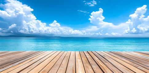 Fototapeta premium Wooden deck in front of clear blue ocean with clouds in the sky