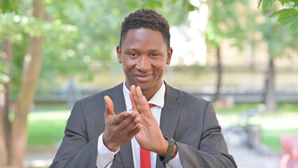 Portrait of Clapping African Businessman Outdoor