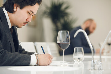 Aspiring Sommelier in Wine Assessment Class. Wine tasting training, wineries and winemaking lecture. Professional development courses.