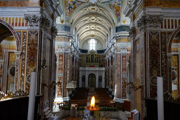 Monopoli cathedral view from the altar in front of a lit candle, Puglia, Italy