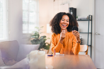 Happy African American Woman Applying Makeup at Home.