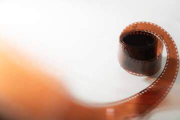 Curled Photographic Film Strip on Light Background