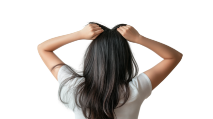 A girl flips her long hair joyfully while standing with her back turned, enjoying a carefree moment in an illuminated setting