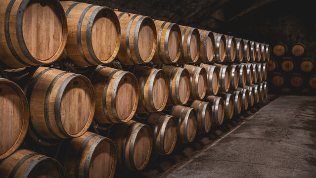 Wooden wine barrels stacked in a vineyard cellar