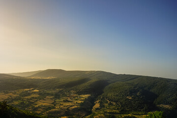 Misty summer sunset over Gargano mountains, Puglia, Italy
