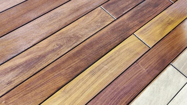 Staining a wood deck with painting brush