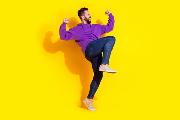 Photo of cheerful nice man wear trendy clothes hands yes scream success isolated on yellow color background