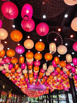 Vibrant Hanging Lanterns in a Festive Indoor Market, Pink, Orange, and White Paper Lanterns.