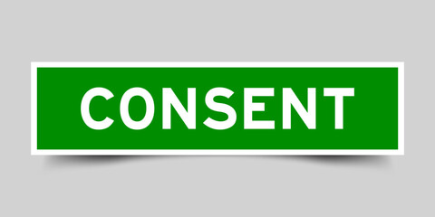 Green color square shape sticker label with word consent on gray background
