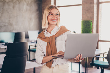 Obraz premium Photo of attractive woman hold netbook look empty space dressed trendy clothes executive business leader comfort beautiful office interior