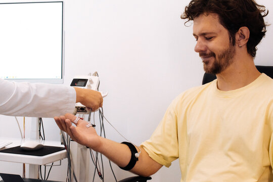 A patient undergoes nerve testing using electromyography (EMG). Perfect for illustrating advanced medical examinations and diagnosing neuromuscular disorders.