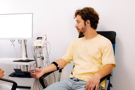 A patient undergoes nerve testing using electromyography (EMG). Perfect for illustrating advanced medical examinations and diagnosing neuromuscular disorders.