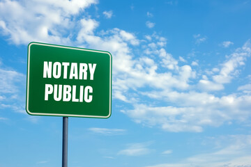 Notary public message written on green road sign with cloudy sky background. Conceptual notary public symbol. Copy space.