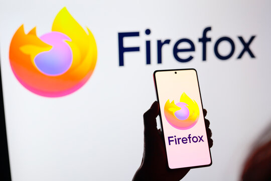 August 15, 2024, Paraguay. In this photo illustration, the from the Mozilla Firefox web browser logo is displayed on a smartphone screen and in the background.