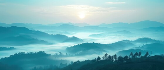 Scenic sunrise over misty mountains, showcasing layers of hills under a soft blue hue with a tranquil, peaceful atmosphere.