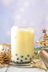 Christmas holiday eggnog boba milk tea cocktail. Trendy eggnog bubble tea or latte with New year and Xmas decorated background, copy space
